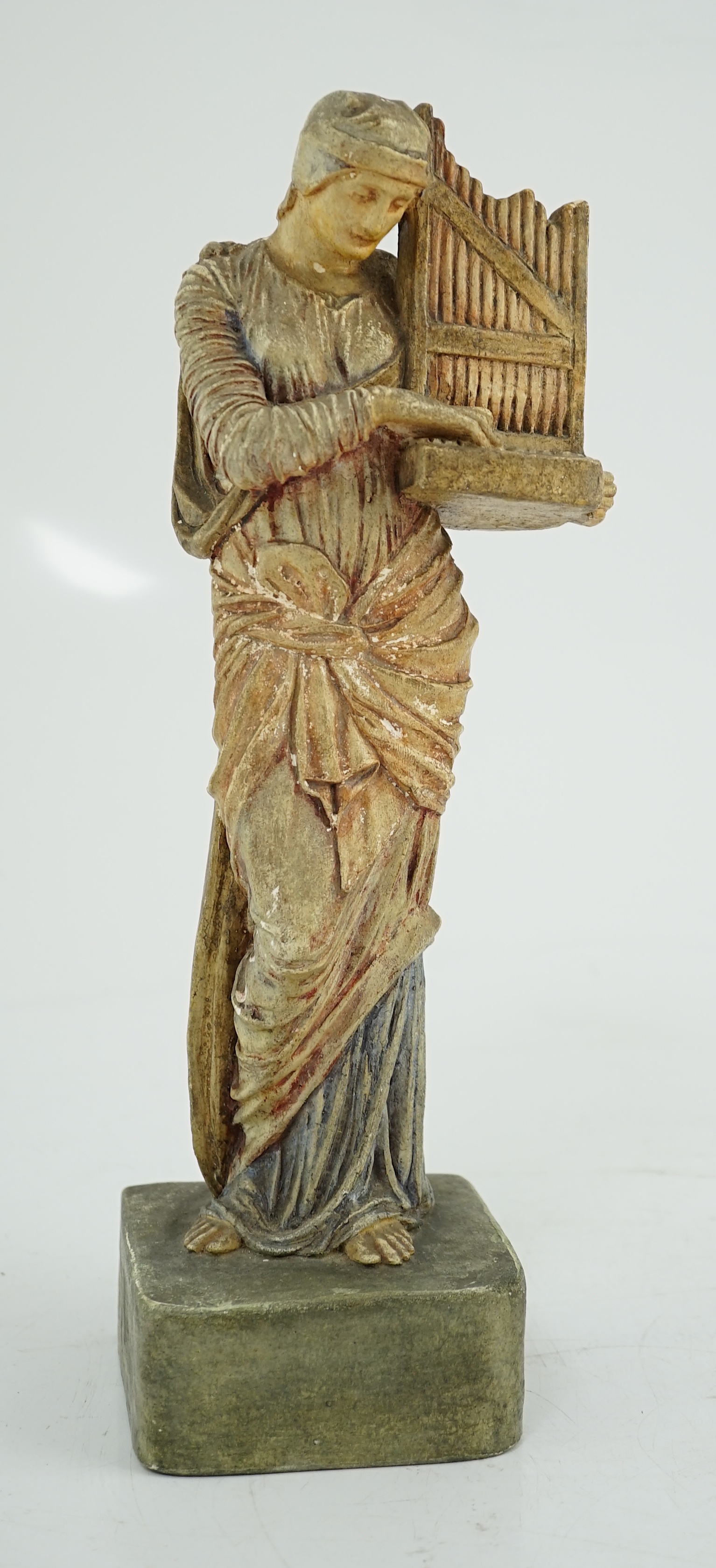 A Compton tempera painted pottery figure of St Cecilia, early 20th century, losses to paint